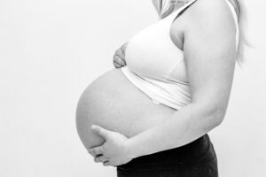 woman holding her baby bump 2220699