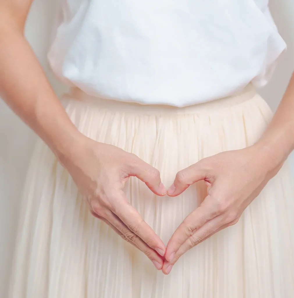 woman hand heart shape over abdomen ovarian and s 2023 11 28 04 24 54 utc e1741602988464